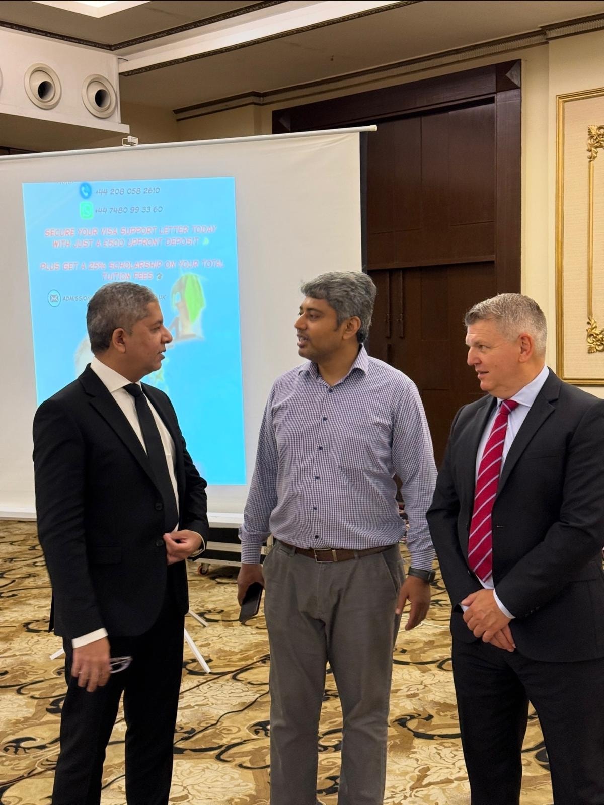 ACE London School Principal in discussion with agents at conference, Lahore