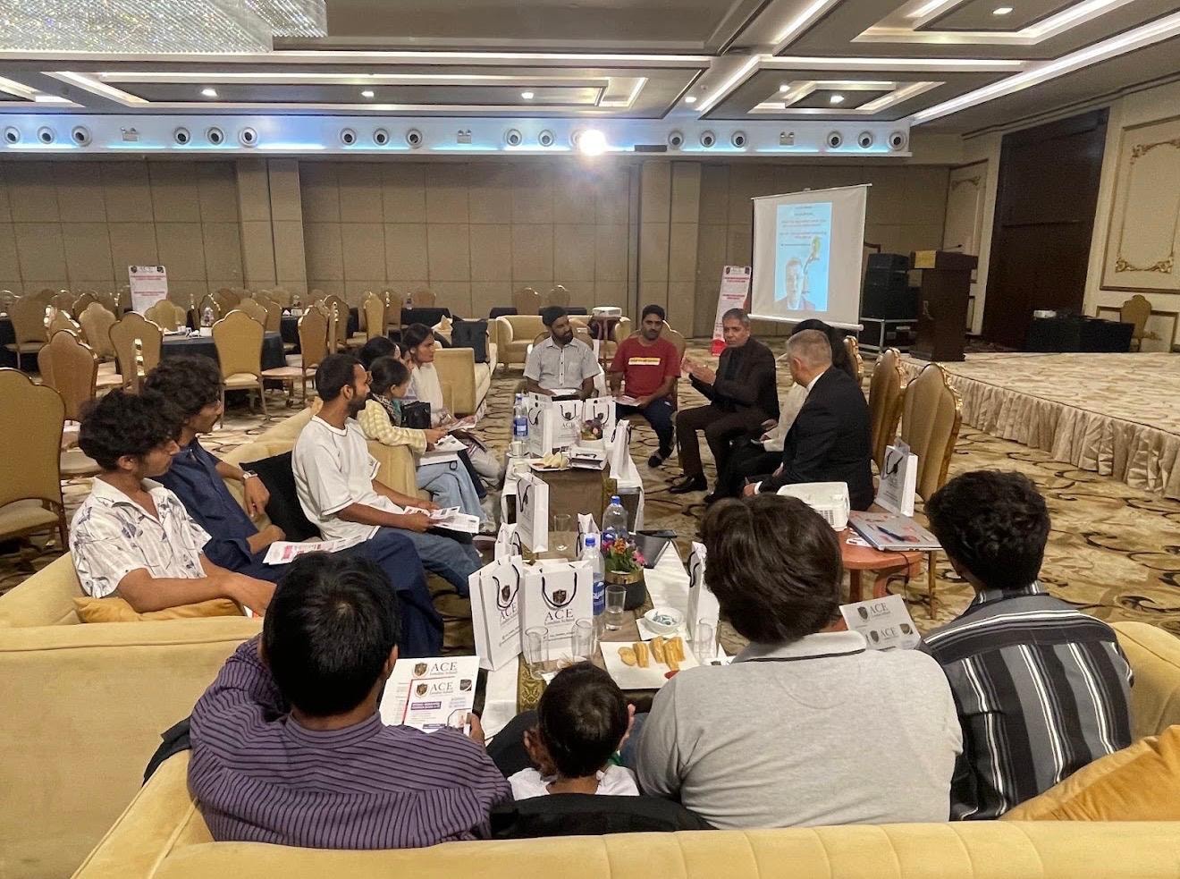 ACE London School Open Day — Principal in discussion with students in hotel ballroom, Pakistan