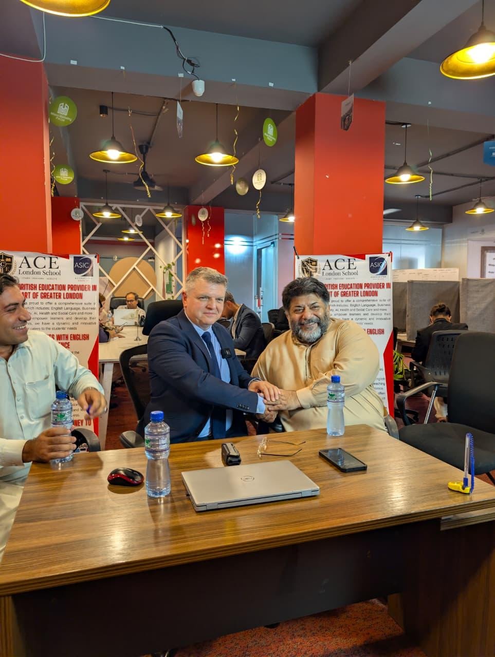 Agents' Conference at Milano Marketing Islamabad — ACE Principal handshake with partner, ACE and ASIC banners visible