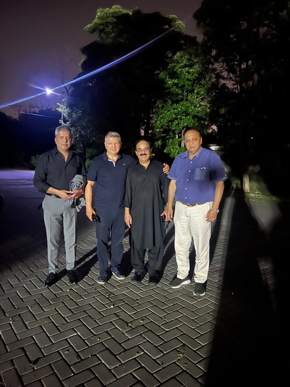 ACE London School Principal with Pakistani partners at evening outdoor meeting, Lahore